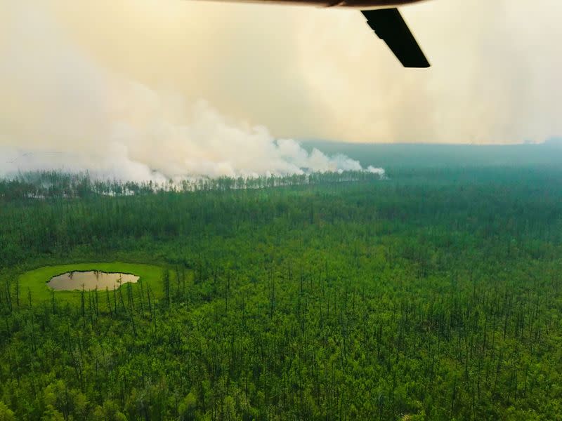 An aerial view shows smoke rising from a forest fire burning in Yakutia