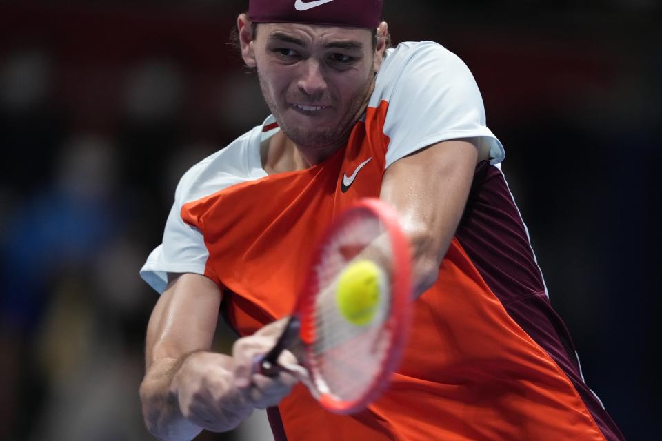 Taylor Fritz of the U.S. returns a shot against Frances Tiafoe of the U.S. during their final match of the Japan Open tennis championships in Tokyo, Sunday, Oct. 9, 2022. (AP Photo/Hiro Komae)