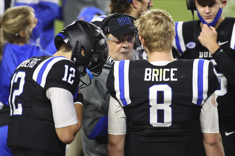 Duke coach David Cutcliffe talks to quarterbacks Chase Brice (8) and Gunnar Holmberg (12) during the second half against Charlotte in an NCAA college football game Saturday, Oct. 31, 2020, in Durham, N.C. (Jaylynn Nash/Pool Photo via AP)