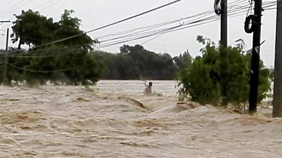 <p>A man trapped in raging flood waters caused by Typhoon Mangkhut is pictured before his rescue in Tarlac, Philippines, in this still image from a Sept. 15, 2018 video from social media.<br>(Photo by Aquino Lord via Reuters) </p>