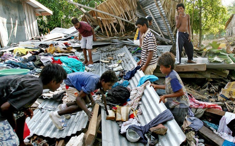 Children hunt for clothes after their Solomon Islands village was hit by a tsunami, on April 5, 2007. A major 8.0 magnitude earthquake has jolted the Solomon Islands with small tsunami waves buffeting Pacific coasts, leaving at least five people dead and dozens of homes damaged or destroyed