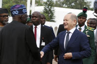 German Chancellor Olaf Scholz, left is welcomed by Nigeria's President Bola Tinubu, right, upon his arrival at the Presidential palace in Abuja, Nigeria, Sunday, Oct. 29, 2023. The German Chancellor Olaf Scholz met with Nigerian President Bola Tinubu on Sunday as part of a West Africa tour as the European country looks to diversify its trade partners and expand economic partnerships in the energy-rich region. (AP Photo)