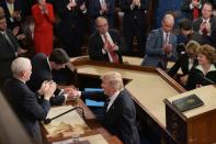 US President Donald Trump (R) shakes hands with House Speaker Paul Ryan after addressing a joint session of Congress at the US Capitol in Washington, DC on February 28, 2017