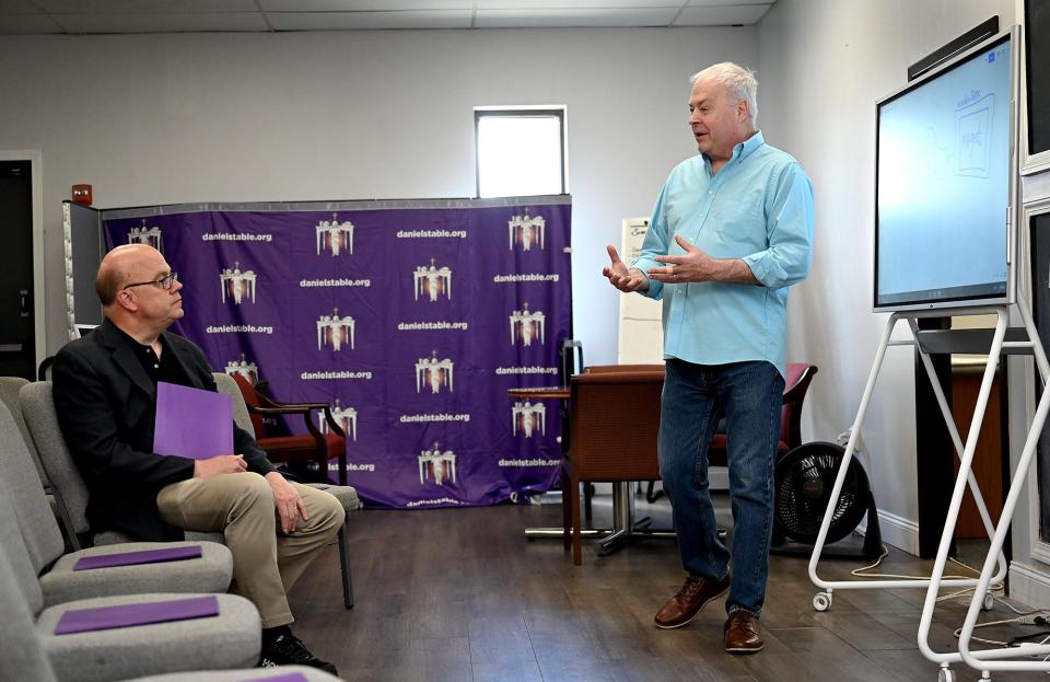David Blais, right, founder of Daniel's Table in Framingham, speaks with U.S. Rep. Jim McGovern about food insecurity solutions during McGovern's visit to the nonprofit, June 28, 2022.