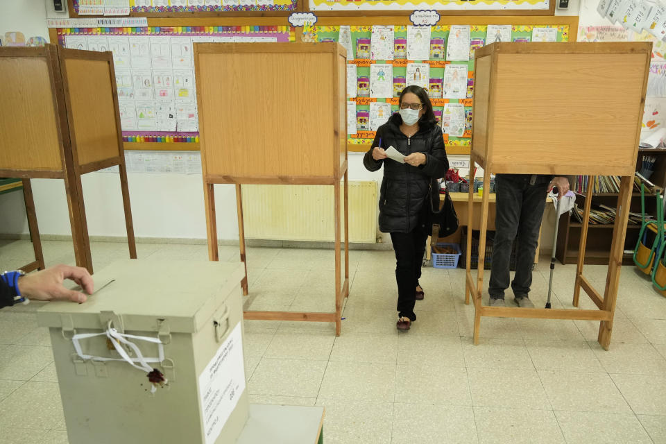 A woman leaves the booth after casting her vote during the presidential elections in Geroskipou in south west coastal city of Paphos, Cyprus, Sunday, Feb. 5, 2023. Cypriots began voting for their eighth new president in the ethnically divided island’s 62-year history as an independent republic, with three front-runners each portraying themselves as the safest bet to guide the country through turbulent economic times and to seek peace with breakaway Turkish Cypriots. (AP Photo/Petros Karadjias)