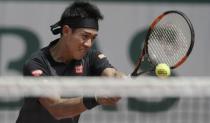 Tennis - French Open - Roland Garros - Kei Nishikori of Japan vs Andrey Kuznetsov of Russia - Paris, France - 25/05/16. Kei Nishikori of Japan returns the ball. REUTERS/Gonzalo Fuentes