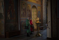 CORRECTS DAY OF THE WEEK Women pray at the St. Michael's Golden-Domed Monastery in Kyiv, Ukraine, Tuesday Jan. 31, 2023. (AP Photo/Daniel Cole)