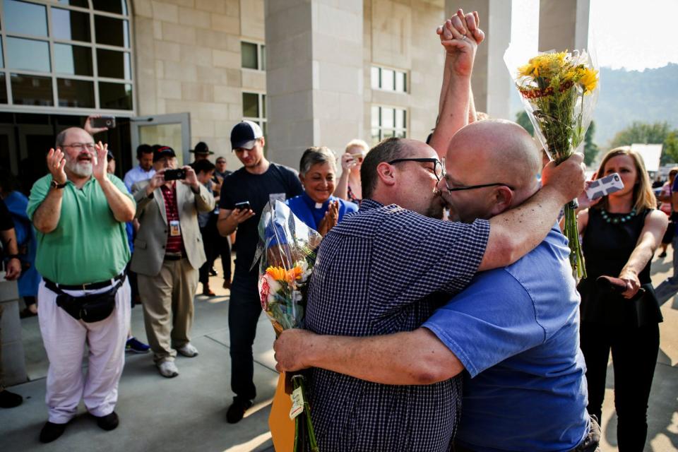 Michael Long, left, and Timothy Long kiss outside the Rowan County Clerk's Office on Friday raising their fist clinched high in to the air after being the second couple to receive marriage license documents following the Kim Davis ruling on Thursday. "In our minds, we've always been married," Timothy said. The decision of Rowan County County Clerk Kim Davis to not issue marriage licenses to same-sex couples thrusted Kentucky in to the national spotlight of the gay marriage debate. Media and hundreds of those with opions on both sides flocked to the streets of Rowan County. For many it was about making their beliefs heard, but for a few it was simply about a piece of paper recognizing their love as equal. Sept. 4, 2015 | Other than Kim Davis