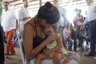 <p>A Venezuelan woman holds a girl at a health post for migrants in Cucuta, along Colombia’s border with Venezuela, Monday, July 16, 2018. (Photo: Christine Armario/AP) </p>