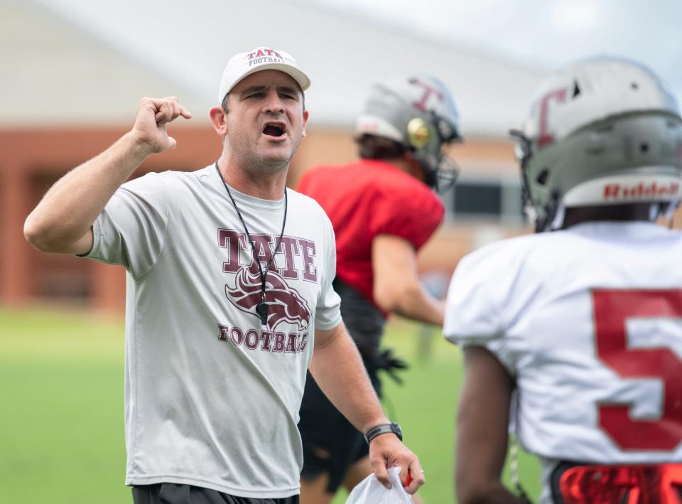 Head coach Rhett Summerford instructs his players during football practice at Tate High School in Cantonment on Wednesday, Aug. 3, 2022.