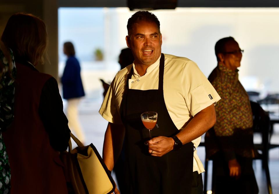 Chef Michael Lugo talks with guests in the rooftop bar during a recent preview of his new restaurant, Pesca Vilano, in Vilano Beach.