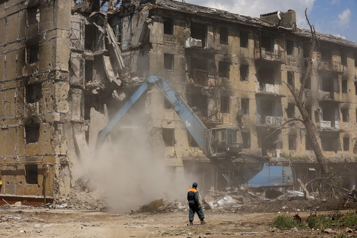 Russian Emergency Situations Ministry workers disassemble a destroyed building in Mariupol, in territory under the government of the Donetsk People's Republic, eastern Ukraine, Friday, May 27. 
