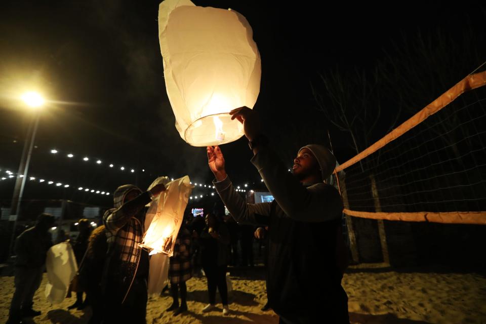 A fan lights a lantern to honor the life of Gangsta Boo during the celebration of life for Gangsta Boo at Railgarten on Jan. 13, 2023 in Memphis.