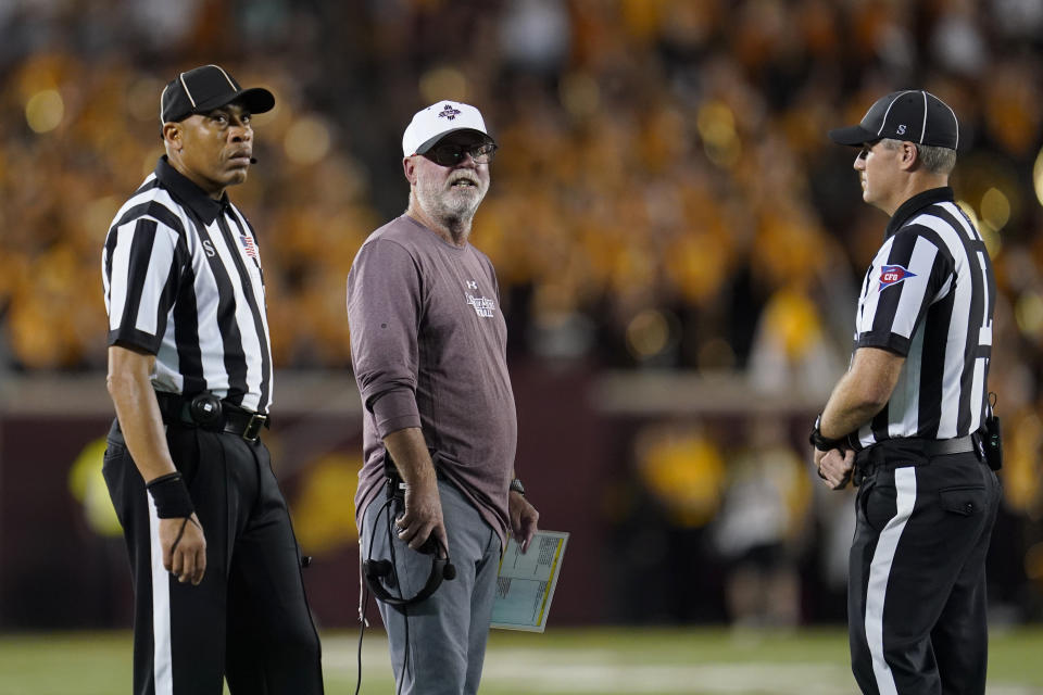 New Mexico State coach Jerry Kill, middle, looks on during a replay review ing the first half of the team's NCAA college football game against Minnesota on Thursday, Sept. 1, 2022, in Minneapolis. (AP Photo/Abbie Parr)