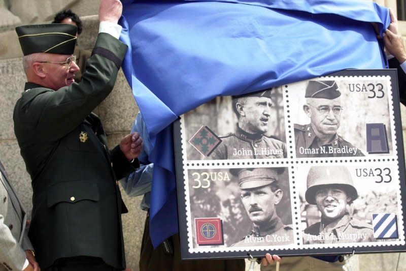 Maj. Gen. Thomas Plewes helps unveil the Distinguished Soldiers stamps at the Soldiers Memorial on May 3, 2000. On October 8, 1918, Sgt. Alvin York (bottom L) of Tennessee became a World War I hero by single-handedly capturing a hill as part of the Meuse-Argonne offensive in France, killing 20 enemy soldiers and capturing 132 others. File Photo by Bill Greenblatt/UPI