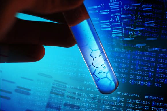 Hand holding test tube with DNA sequences and chemical structures in background