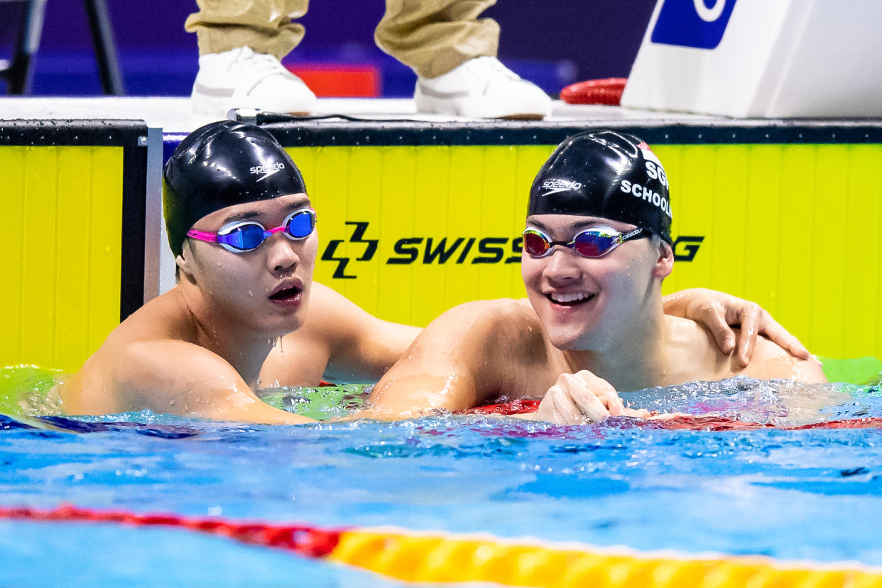 Singapore swimmer Teong Tzen Wei (left) being congratulated by compatriot Joseph Schooling after he won the men's 50m butterfly final ahead of the Olympic champion. (PHOTO: SNOC/Andy Chua)