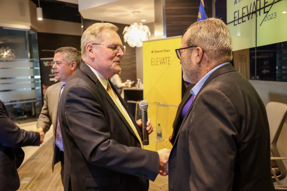 Desert News Executive Editor Doug Wilks shakes hands with Nevada Independent CEO Jon Ralston during the Deseret Elevate Forum at the Las Vegas Metro Chamber of Commerce in Las Vegas, Nev., on Tuesday, Oct. 24, 2023. | Ian Maule, for the Deseret News