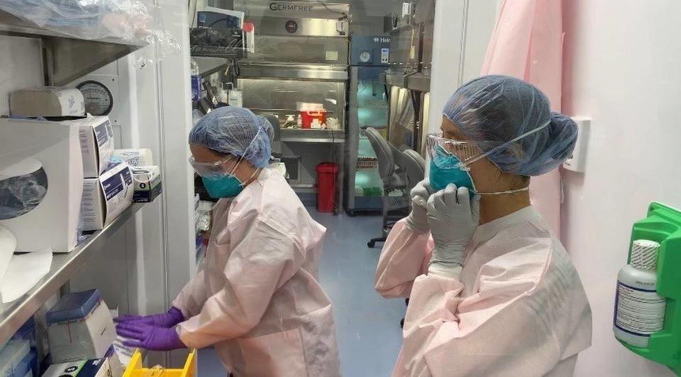 Two lab technicians suit up to begin the process of testing samples for COVID-19 on the campus of Miami Cancer Institute. Photo provided by Baptist Health South Florida 