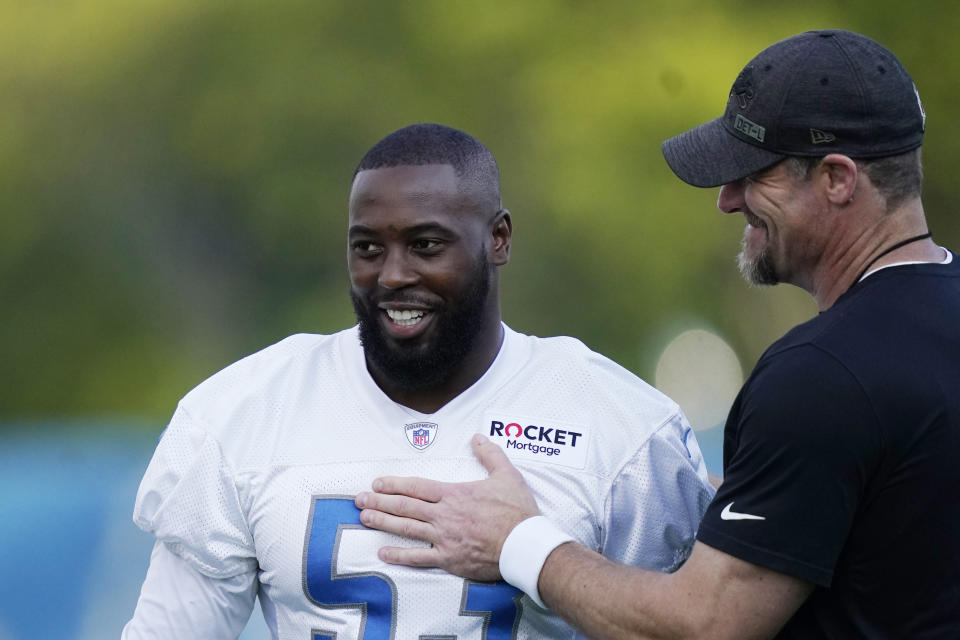 Detroit Lions head coach Dan Campbell greets offensive linebacker Charles Harris before drills at the Lions NFL football camp practice, Wednesday, July 28, 2021, in Allen Park, Mich. (AP Photo/Carlos Osorio)