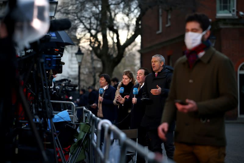 Television reporters react in Downing Street in London