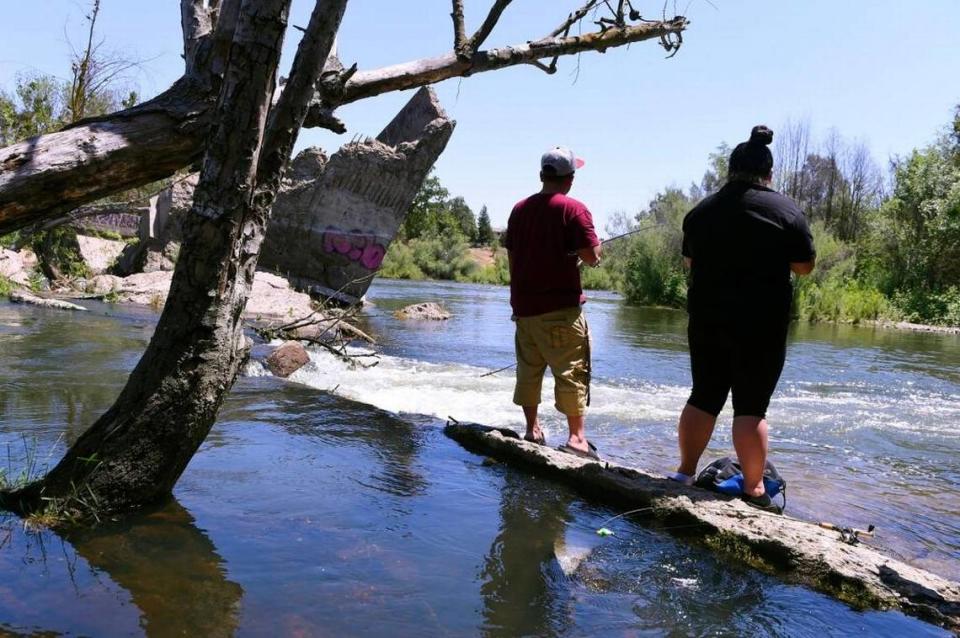 Cheng Her, left, and his wife Linda Moua, right, fish the San Joaquin River at Friant’s Broken Bridges Tuesday afternoon, May 15, 2018.