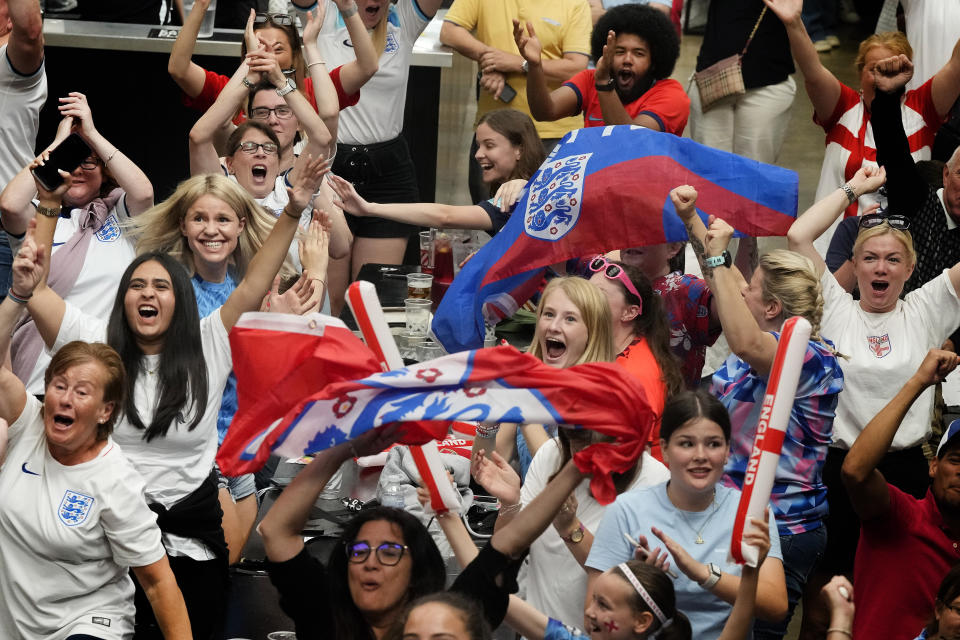 England fans cheer as England score their first goal at the screening of the Women's World Cup 2023 semifinal soccer match between England and Australia at BOXPARK Wembley in London, Wednesday, Aug. 16, 2023. (AP Photo/Frank Augstein)