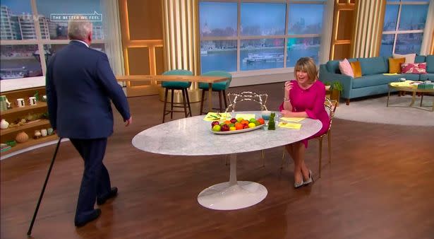 Eamonn Holmes hobbled back onto screen using a stick. (ITV)