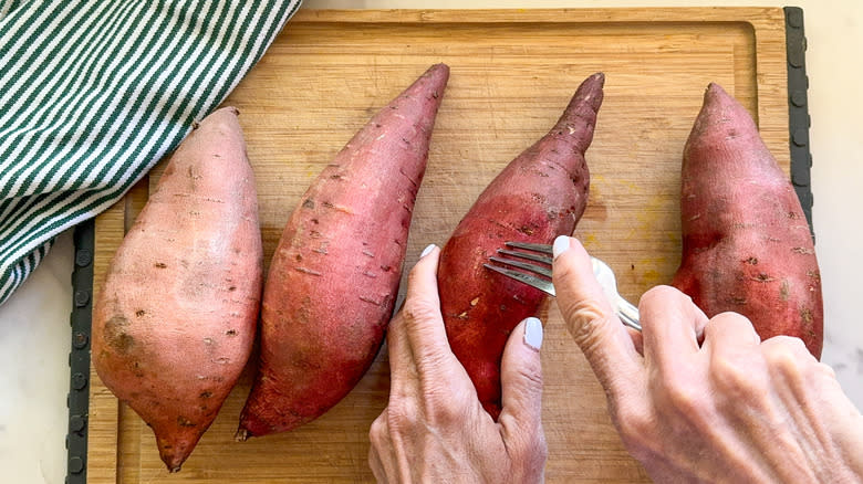 poking sweet potato with fork