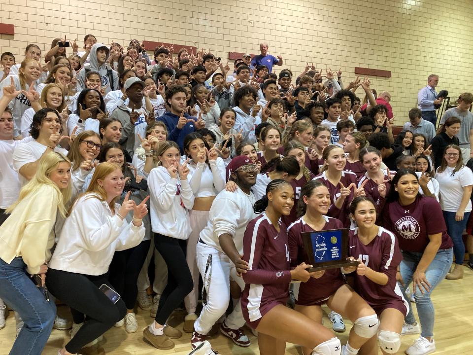 The Morristown volleyball team celebrates after defeating Livingston to win the program's first NJSIAA sectional title on Nov. 7, 2023.