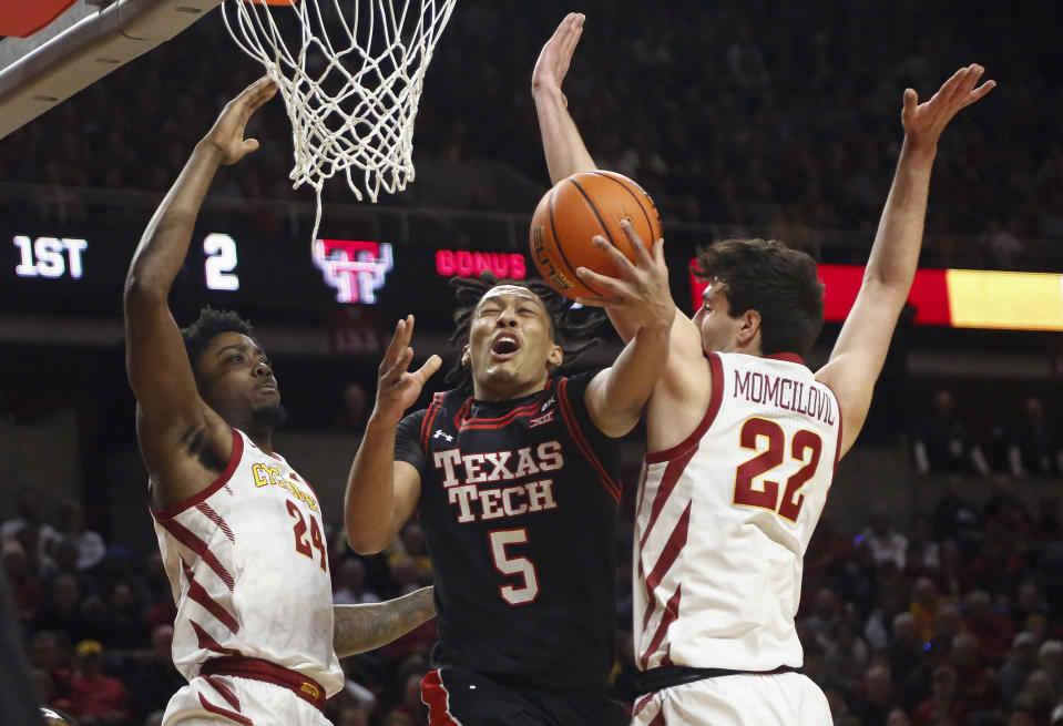 Texas Tech guard Darrion Williams drives to the basket as Iowa State's Hason Ward (24) and Milan Momcilovic (22) defend in the first half of an NCAA college basketball game, Saturday, Feb. 17, 2024, in Ames, Iowa. (AP Photo/Bryon Houlgrave)