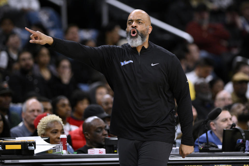 Washington Wizards coach Wes Unseld Jr. gestures during the first half of the team's NBA basketball game against the Miami Heat, Friday, April 7, 2023, in Washington. (AP Photo/Nick Wass)