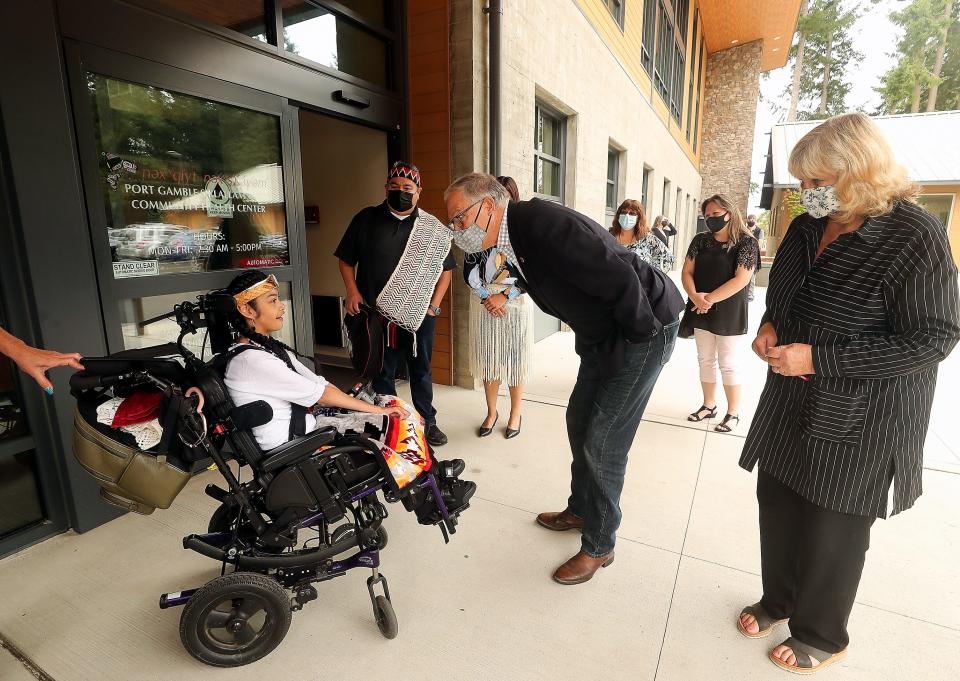 Port Gamble S'Klallam Tribe member Dinae Sullivan greets Washington Gov. Jay Inslee and his wife, Trudi Inslee, as they arrive for a tour of the Port Gamble S'Klallam Tribe Community Health Center in Kitsap County's Little Boston community Friday.