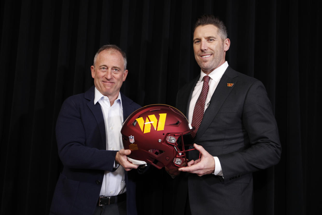 Washington Commanders owner Josh Harris, left, and Adam Peters, right, pose for a photo after Peters was introduced as the team's new general manager during an NFL press conference, Tuesday, Jan. 16, 2024, in Ashburn, Va. (AP Photo/Luis M. Alvarez)