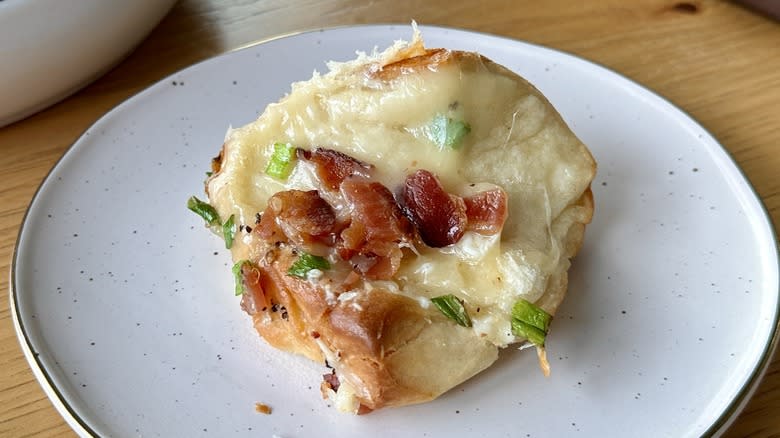 Slice of bacon Cheddar bread on plate