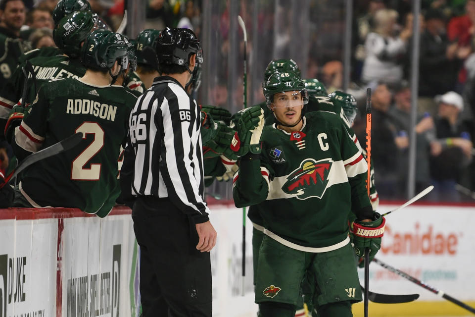 Minnesota Wild defenseman Jared Spurgeon, right, celebrates with the bench after scoring against the Ottawa Senators during the second period of an NHL hockey game, Sunday, Dec. 18, 2022, in St. Paul, Minn. (AP Photo/Craig Lassig)