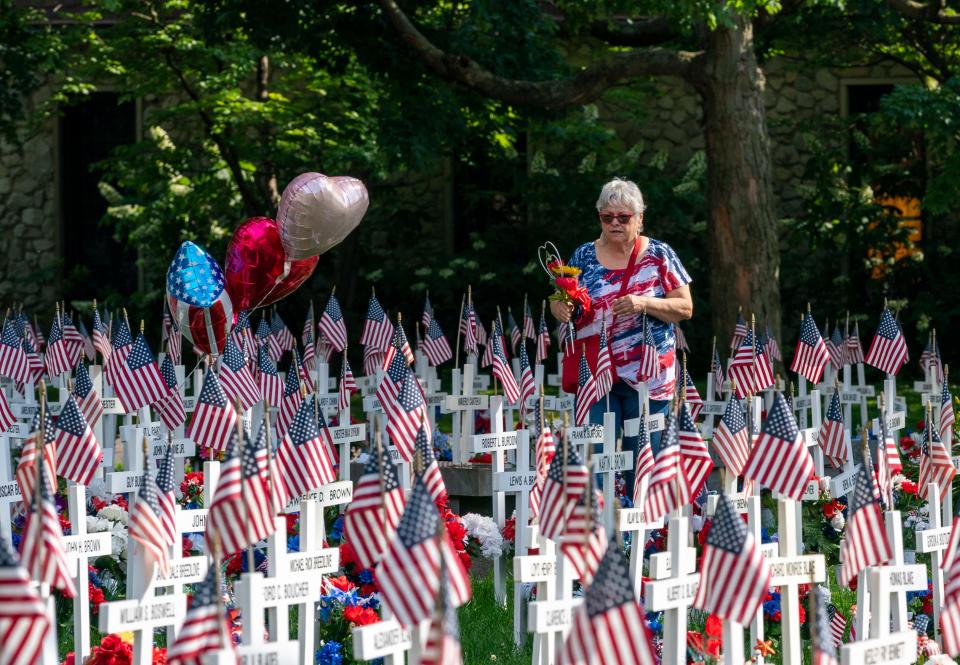 Rebecca Brown walks through the 6,160 crosses on display for Memorial Day in Henderson's Central Park looking for her husband William Brown’s name Thursday, May 16, 2024.