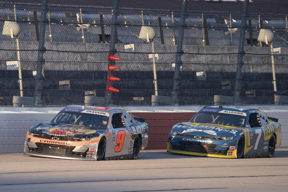 Noah Gragson (9) and Justin Allgaier (7) drive during the NASCAR Xfinity Series auto race Saturday, Sept. 3, 2022, at Darlington Raceway in Darlington, S.C. Gragson passed Sheldon Creed on the final lap to win. (AP Photo/Sean Rayford)