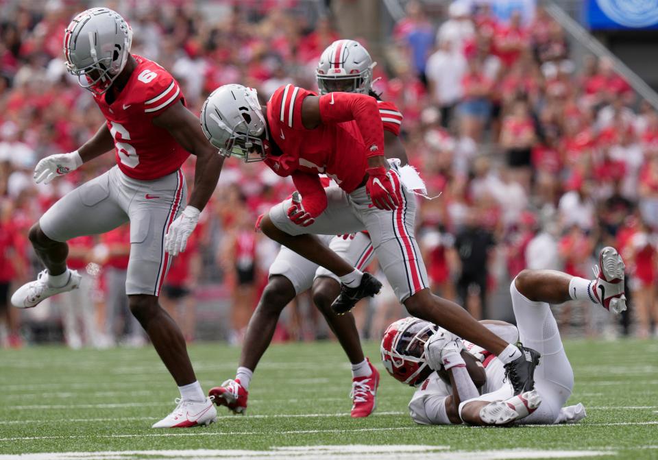 Sept. 9, 2023; Columbus, Oh., USA; 
Youngstown State Penguins wide receiver Bryce Oliver (0) is tackled by Ohio State Buckeyes safety Sonny Styles (6) and Ohio State Buckeyes cornerback Davison Igbinosun (1) during the first half of Saturday's NCAA Division I football game at Ohio Stadium.