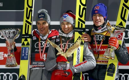 Ski Jumping - 65th four-hills ski jumping tournament final round - Bischofshofen, Austria - 06/01/2017 - Poland's Kamil Stoch, compatriot Piotr Zyla and Norway's Daniel Andre Tande pose on the podium after the final stage of the 65th four-hills tournament. REUTERS/Dominic Ebenbichler