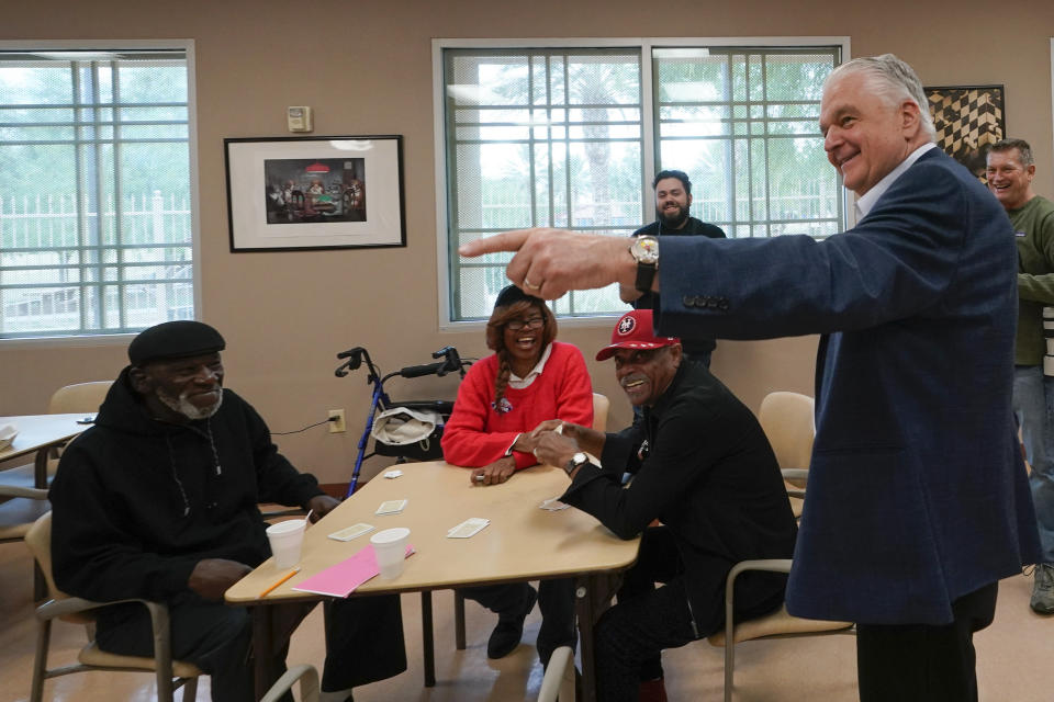 Nevada Gov. Steve Sisolak, right, greets people during a campaign event Tuesday, Nov. 8, 2022, in Las Vegas. (AP Photo/Gregory Bull)