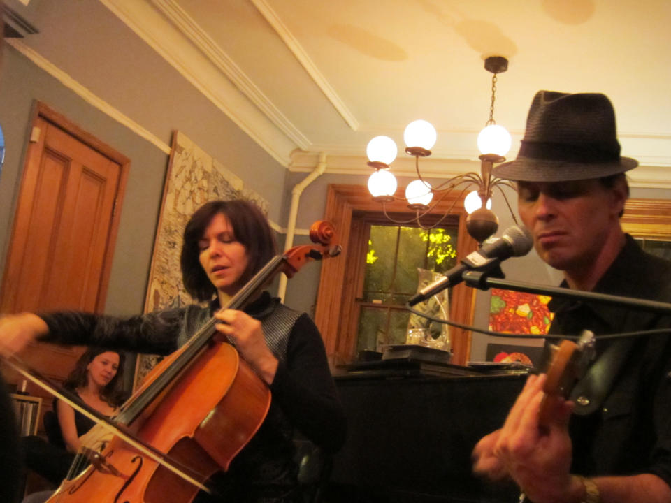 This image taken in 2011 shows cellist and singer Helen Gillet, left, and Clint Maedgen, a member of the venerable Preservation Hall Jazz Band, performing in a living room show, in the Brooklyn borough of New York. Maedgen, and his collaborator girlfriend, Gillet, performed at this private concert and also played the Kennedy Center this past spring. Gillet describes house concerts as having an intimacy almost like family. (AP Photo/John Tebeau)