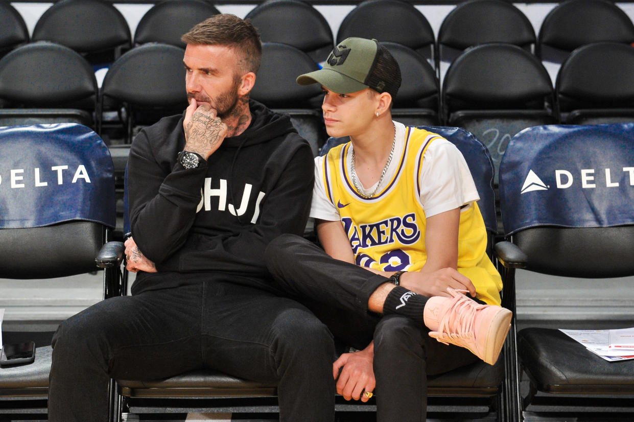 LOS ANGELES, CALIFORNIA - OCTOBER 27: David Beckham (L) and his son Romeo Beckham attend a basketball game between the Los Angeles Lakers and the Charlotte Hornets at Staples Center on October 27, 2019 in Los Angeles, California. (Photo by Allen Berezovsky/Getty Images)