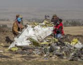 FILE - In this March 11, 2019, file photo, rescuers work at the scene of an Ethiopian Airlines flight crash outside of Addis Ababa, Ethiopia. Ethiopian Airlines’ former chief engineer Yonas Yeshanew, who is seeking asylum in the U.S., says in a whistleblower complaint filed with regulators that the carrier went into maintenance records on a Boeing 737 Max jet after it crashed this year, a breach he contends was part of a pattern of corruption that included routinely signing off on shoddy repairs. (AP Photo/Mulugeta Ayene, File)