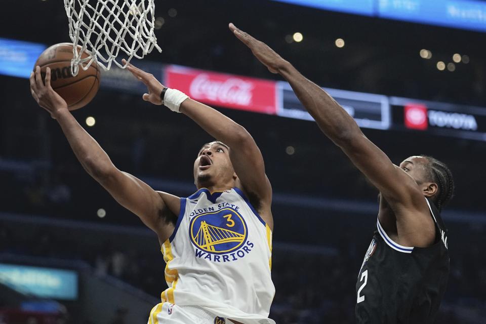 Golden State Warriors guard Jordan Poole, left, shoots as Los Angeles Clippers forward Kawhi Leonard defends during the first half of an NBA basketball game Tuesday, Feb. 14, 2023, in Los Angeles. (AP Photo/Mark J. Terrill)