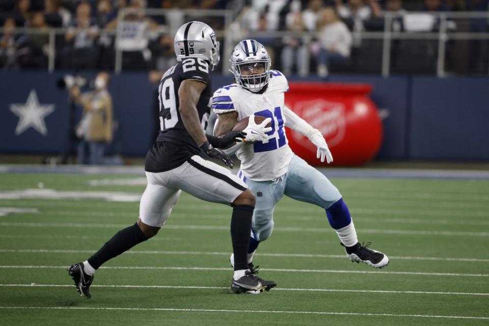 Las Vegas Raiders cornerback Casey Hayward Jr. (29) defends as Dallas Cowboys running back Ezekiel Elliott (21) runs the ball in the first half of an NFL football game in Arlington, Texas, Thursday, Nov, 25, 2021. (AP Photo/Ron Jenkins)