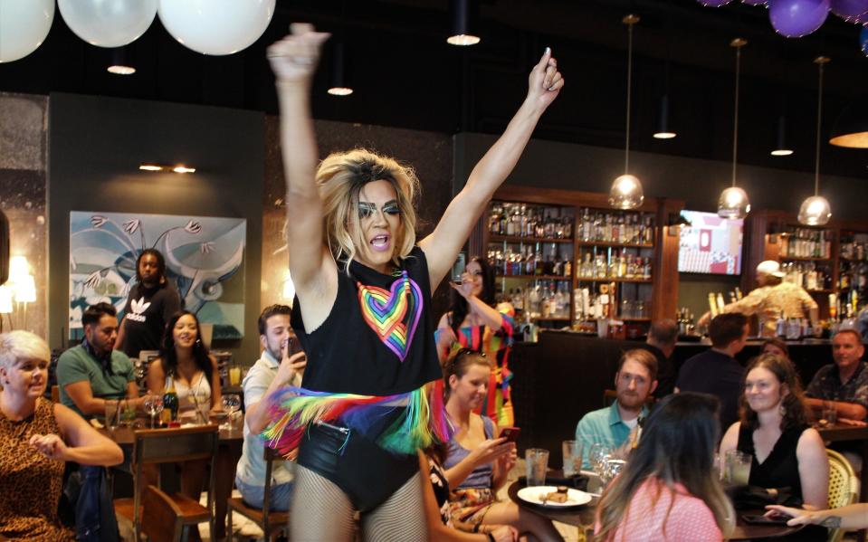 Drag queen Jayca dances through the crowd, arms up Saturday at The Local, where a drag brunch was held. June 13 2020