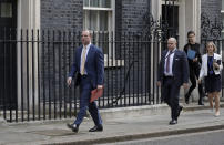 Britain's Secretary of State for Foreign Affairs, Dominic Raab, left, leads cabinet members as they leave 10 Downing Street after a meeting as British Prime Minister Boris Johnson was moved to intensive care after his coronavirus symptoms worsened in London, Tuesday, April 7, 2020. Johnson was admitted to St Thomas' hospital in central London on Sunday after his coronavirus symptoms persisted for 10 days. Having been in hospital for tests and observation, his doctors advised that he be admitted to intensive care on Monday evening. The new coronavirus causes mild or moderate symptoms for most people, but for some, especially older adults and people with existing health problems, it can cause more severe illness or death.(AP Photo/Matt Dunham)