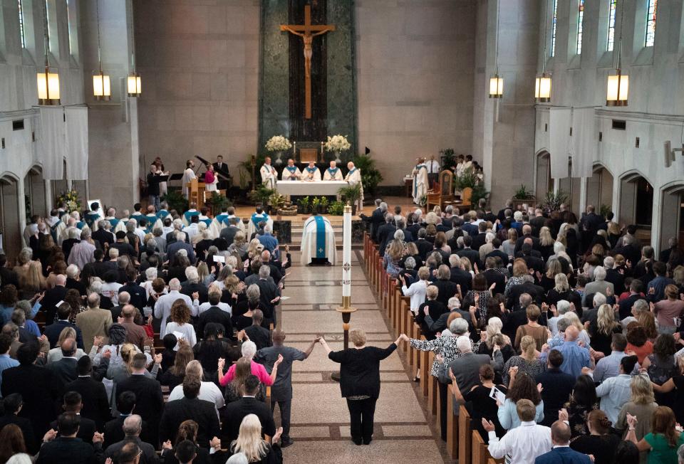 Parishioners prepare for the eucharist during the funeral Mass for the Rev. Joseph Patrick Breen at Christ the King Catholic Church Friday, May 27, 2022, in Nashville, Tenn.