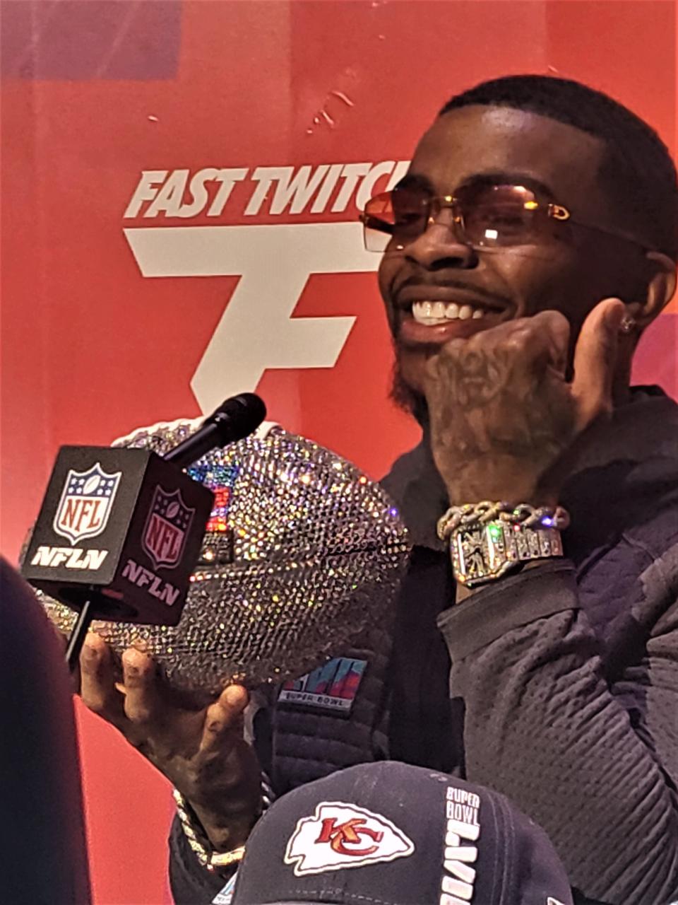 Kansas City running back Jerick McKinnon holds a jeweled football while showing off his watch during Opening Night for Super Bowl 57 at the Footprint Center on Feb. 6, 2023.